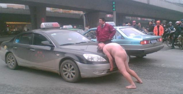 A naked man has become famous in China after he stopped traffic on a busy 