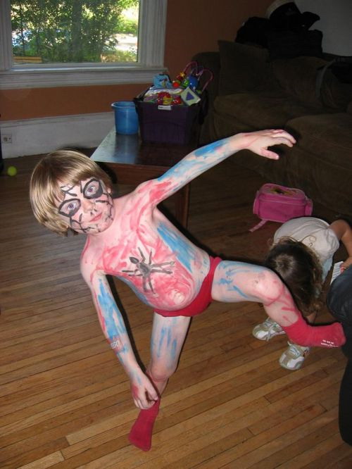 Kid in painted Spiderman costume